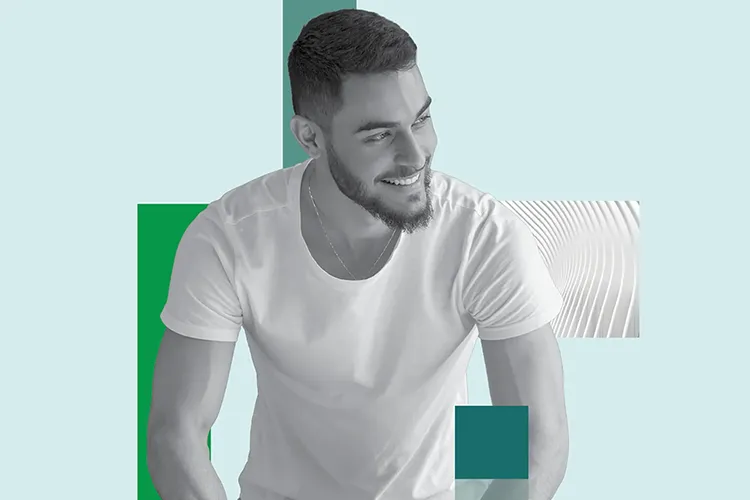 A massage therapist works on a prone client's lower leg.