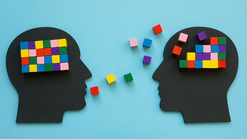 Heads with colorful cubes as a symbol of mentoring.
