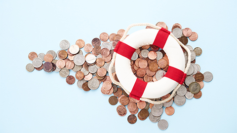 Image of a lifebuoy on top of pennies, dimes, nickels, and quarters.
