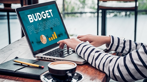 Close up hand of influencer budget planning for online media advertising at cafe restaurant.online marketing concept.