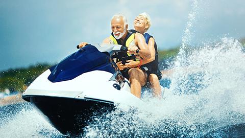 Image of two people riding on a jet ski.
